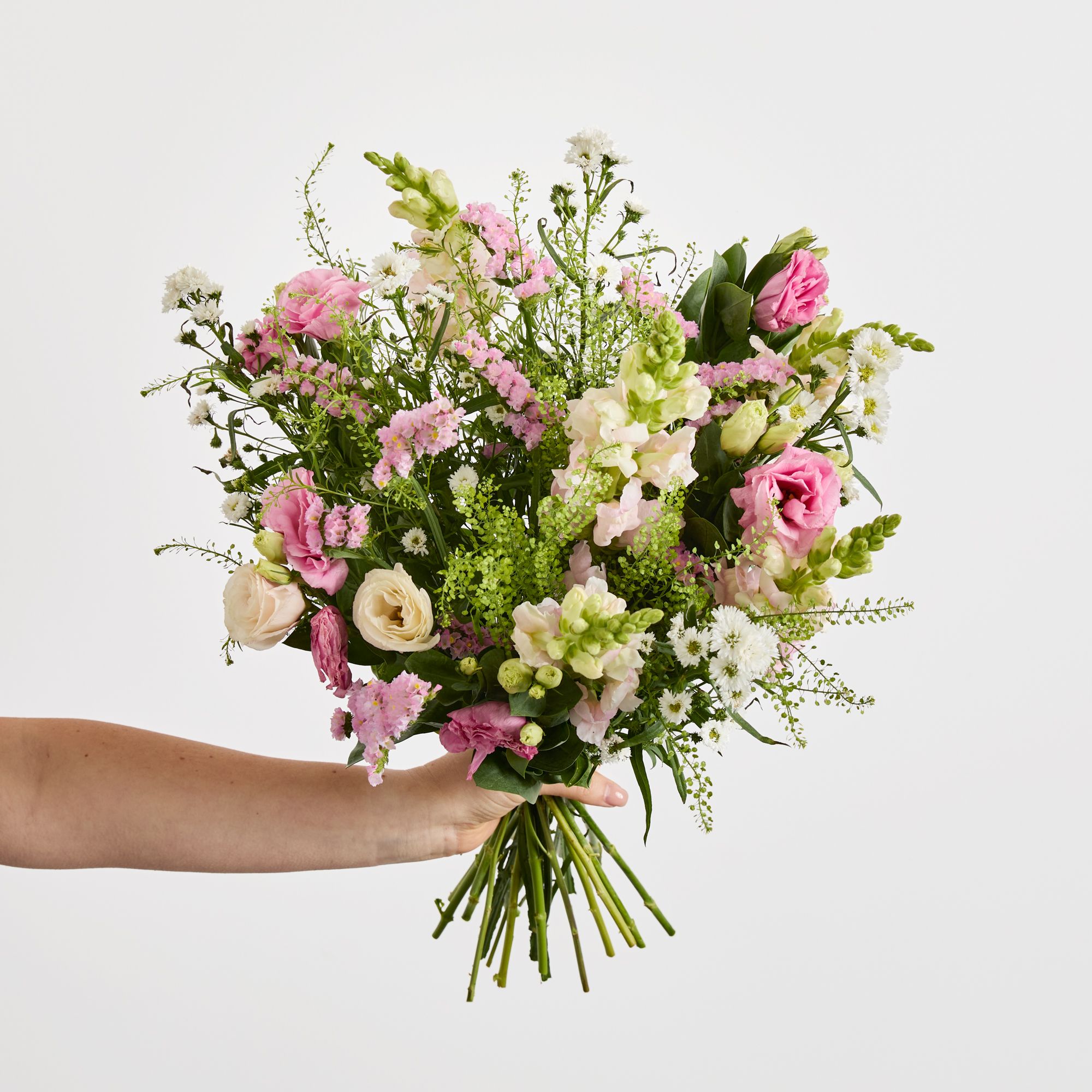 White asters, pink antirrhinum, pink statice, pink lisianthus and greenbell