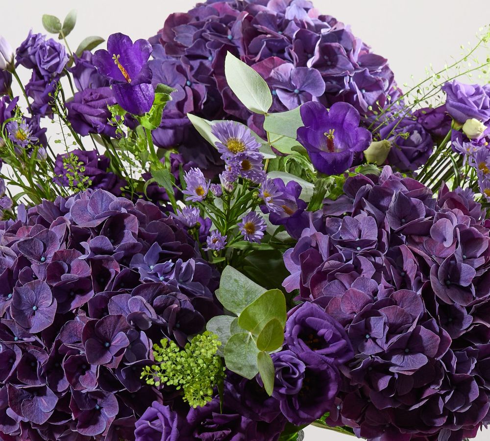 A close crop of our Purple Reign bouquet, featuring purple hydrangeas, asters, lisianthus and campanula